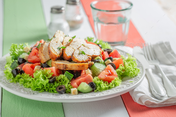 Healthy and classic Caesar salad with cucumber, chicken and tomatoes. - Stock Photo - Images