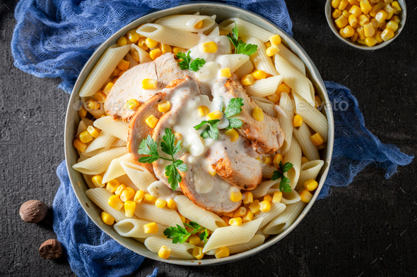 Fresh and delicious pasta with chicken and corn. - Stock Photo - Images