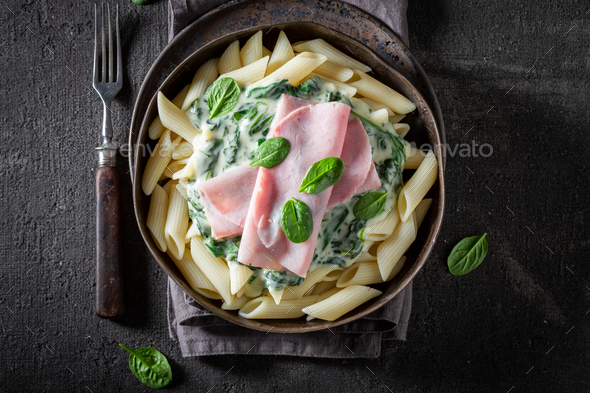 Delicious and fresh pasta with ham and bechamel sauce. - Stock Photo - Images
