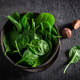 Green spinach leaves and nutmeg in dark bowl - PhotoDune Item for Sale