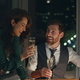Partners rejoicing business achievement drinking champagne in office late night. - PhotoDune Item for Sale