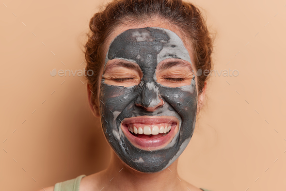 Graceful lady adorns flawless complexion with revitalizing face mask unlocking secrets to ageless