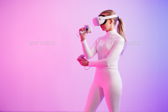 Female athlete in VR glasses practicing martial arts - Stock Photo - Images