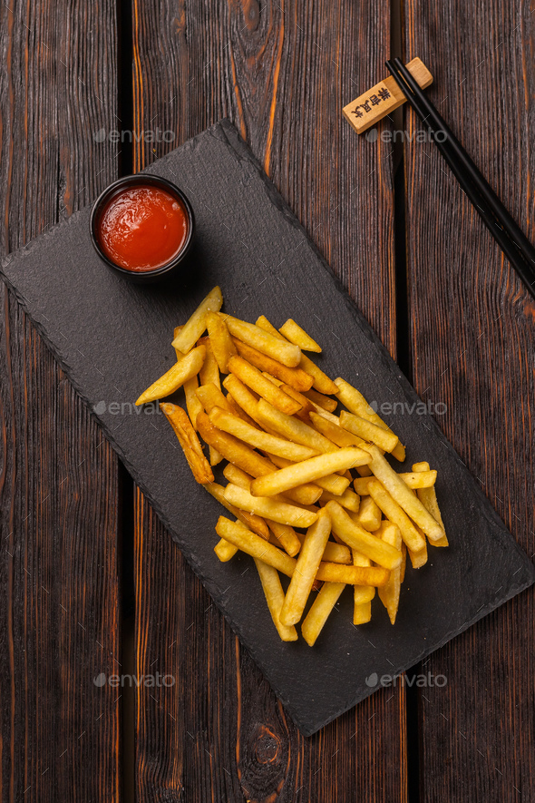 French fries with ketchup on dark wooden background top view - fast food and unhealthy eat concept - Stock Photo - Images