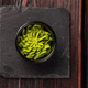 Green wasabi sauce or paste in bowl on wooden background top view - PhotoDune Item for Sale