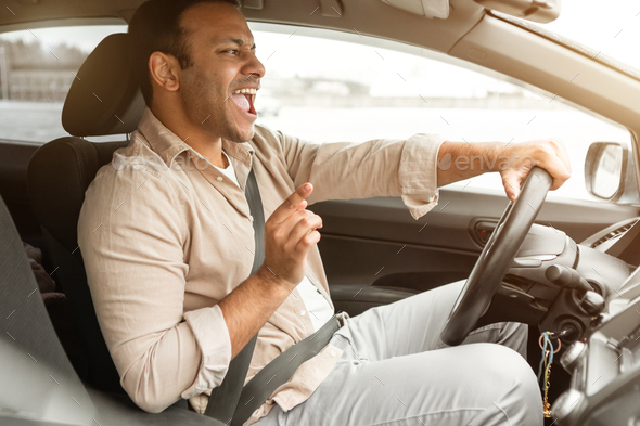 Joyful Indian Driver Man Singing While Driving His New Car