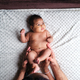 Top view of a nude african newborn with his mother - PhotoDune Item for Sale
