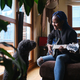 African woman playing the guitar next to a dog at home - PhotoDune Item for Sale