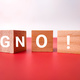 Wooden block with the word G N O on red and white background. - PhotoDune Item for Sale