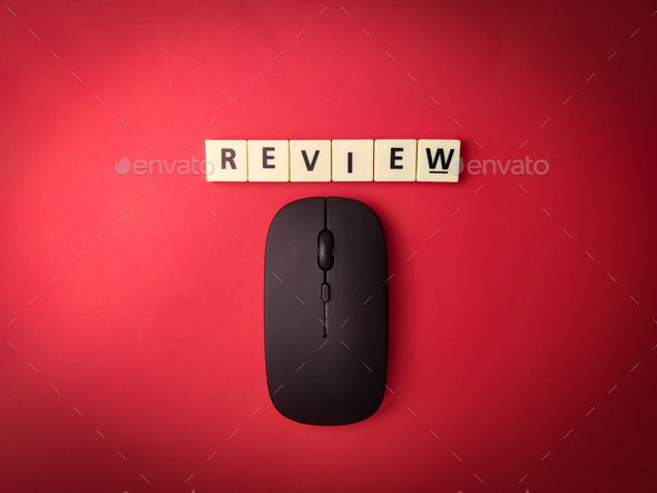 Toys word and wireless mouse with the word REVIEW on red background - Stock Photo - Images
