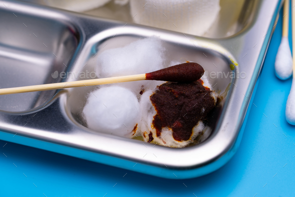 Wound care dressing set and stainless steel plate on blue background. Cotton ball and cotton stick - Stock Photo - Images