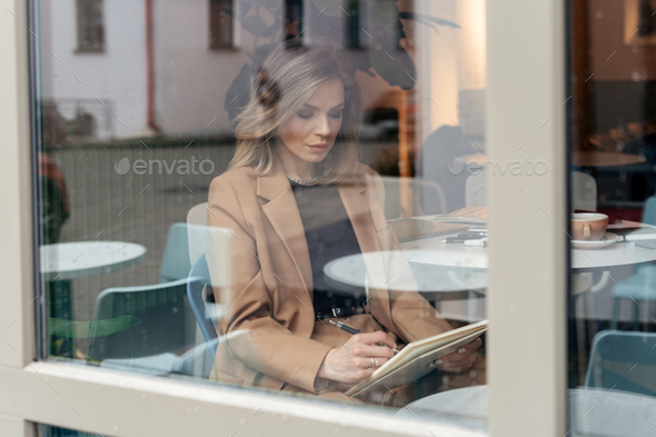 Portrait of a beautiful business woman working in cafe. illustrator working in the cafe - Stock Photo - Images