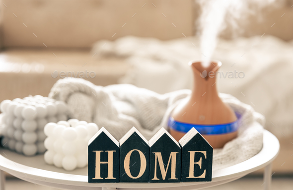Home composition with aroma diffuser lamp and candle on a blurred background. - Stock Photo - Images