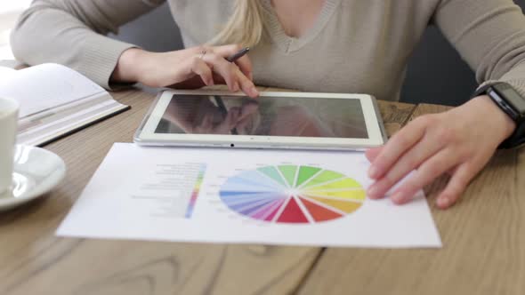 An accountant girl works with the company's growth charts in a freelance format