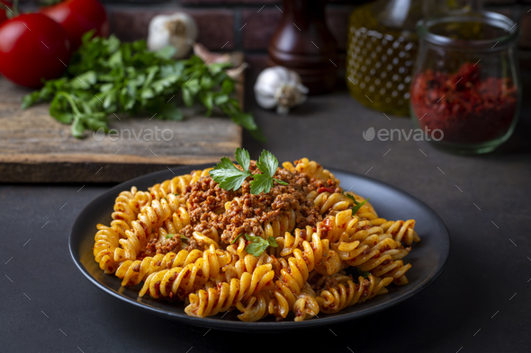 Fusilli pasta, spiral or spirali pasta with tomato, minced sauce - Italian food style - Stock Photo - Images