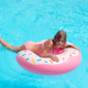 Pretty little girl swimming in outdoor pool and have a fun with inflatable circle - PhotoDune Item for Sale