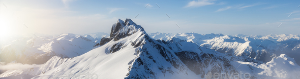 Rugged Canadian Mountain Peak Covered in Snow. Aerial Landscape - Stock Photo - Images