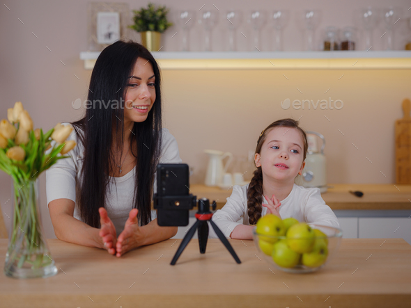 Blogger mom with her baby at home. Millennial Influencer woman creating content for her motherhood - Stock Photo - Images