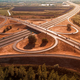 Aerial shot of freeway loop with many vehicles driving in various directions, drone pov - PhotoDune Item for Sale