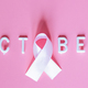Flat lay top view of word October with pink ribbon - symbol of breast cancer awareness months - PhotoDune Item for Sale
