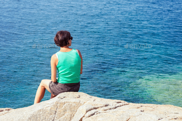 Young woman looking at sea - Stock Photo - Images