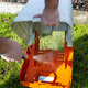 A man washes a dirty mower basket with water. - PhotoDune Item for Sale