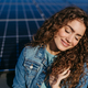 Portrait of young woman on roof with solar panels. - PhotoDune Item for Sale
