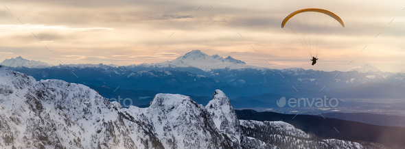 Paraglider flying over Canadian Mountain Landscape. Extreme Adventure Composite. - Stock Photo - Images