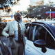 Black Man Adjusts Jacket near Car - PhotoDune Item for Sale