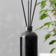 Bamboo sticks in a black bottle with indoor perfumes. Glass diffuser with fragrance for home. - PhotoDune Item for Sale