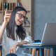 Cheerful young woman in glasses in front of a laptop. - PhotoDune Item for Sale