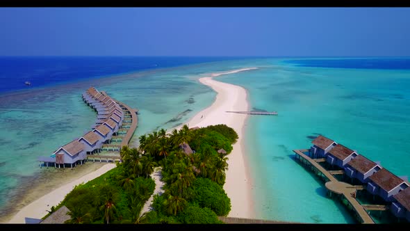 Aerial above landscape of tranquil tourist beach vacation by blue water and white sandy background o alt