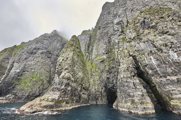 Stunning green cliffs and cave. Atlantic ocean, Faroe islands. - Stock Photo - Images