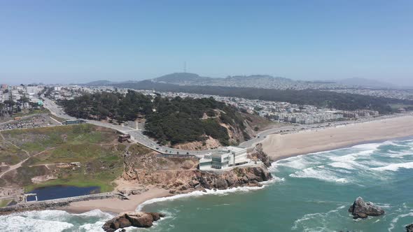Descending aerial shot of the Cliff House at Land's End Lookout in San Francisco. 4K alt