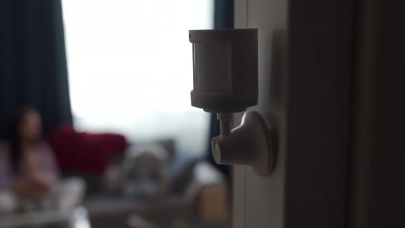 Smart Home Wireless Motion Sensor Installed on the Wall of the Living Room Motion Detector Used to alt