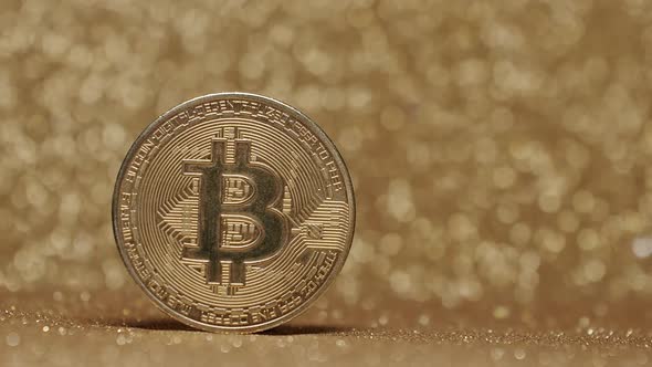Close Up on gold background with bokeh. Bitcoin BTC coin. New virtual currency. alt
