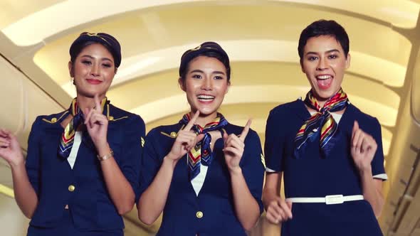 Cabin Crew Dancing with Joy in Airplane alt