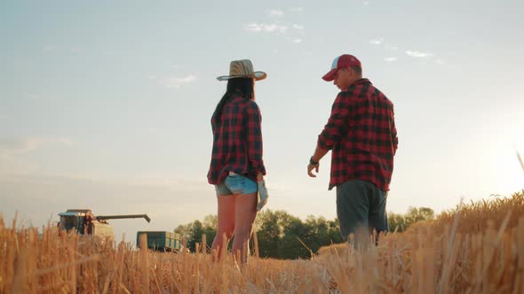 Farmers Handshake Over the Wheat Crop in Harvest Time. Team Farmers Stand in a Wheat Field with alt