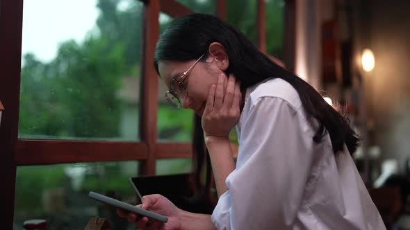 Young Asian woman person using mobile phone chatting online with friends and watching movie videos. alt