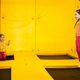 Siblings jumping on trampoline at yellow playground park.  - PhotoDune Item for Sale