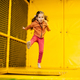 Little girl kid jumping on trampoline at yellow playground park.  - PhotoDune Item for Sale