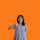 Bright young asian woman inviting to call isolated on orange background - PhotoDune Item for Sale