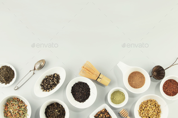 assortment of dry tea in white ceramic bowls - Stock Photo - Images