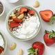 Greek yogurt, nuts and strawberries in a glass jars on a white table top view - PhotoDune Item for Sale