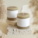 Candle with label on beige stone near dried pampas grass close up, copy space, mock up - PhotoDune Item for Sale