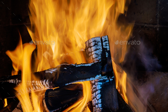 As the temperatures drop in winter, the traditional rural fireplace becomes the heart of the home - Stock Photo - Images