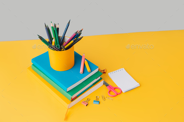 School supplies with books on yellow background - Stock Photo - Images