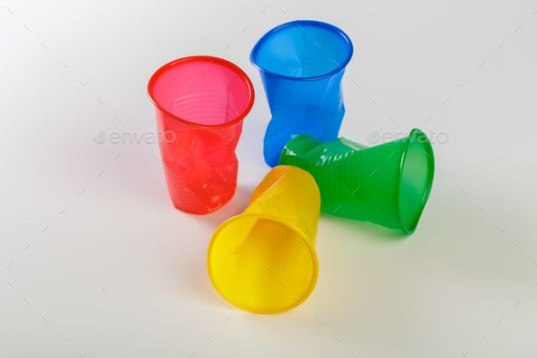 Multicolor disposable plastic glasses isolated on white background - Stock Photo - Images