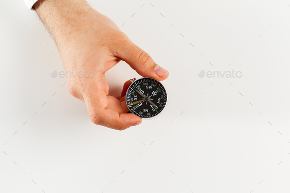 Businessman with a compass holding in hand - Stock Photo - Images