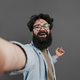 Man taking selfie against grey background - PhotoDune Item for Sale